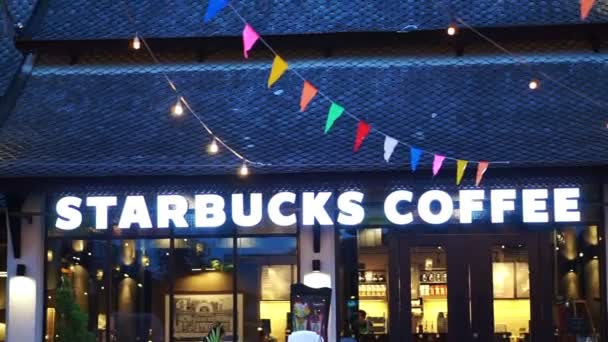 Chiangmai, Thailand - 6 September 2016: Starbucks coffee illuminate sign with classic Thailand architecture lighting and festival decoration — Stock Video