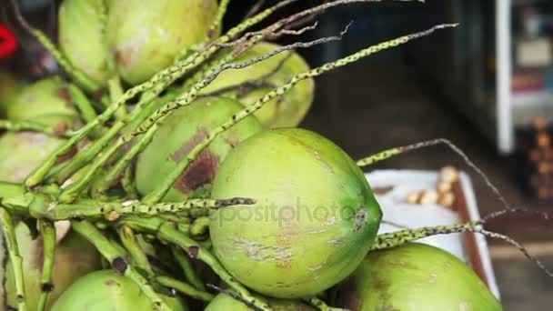 Whole fresh pile of fresh from the tree coconuts selling at local house front — Stock Video