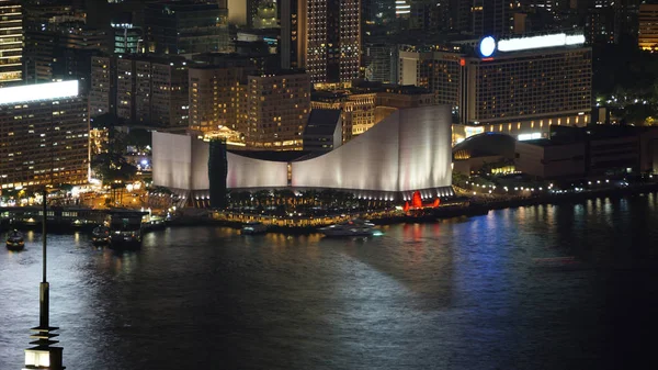 stock image Hong Kong Victoria harbour and its iconic red ancient junk sail zoom shot from the Peak at night