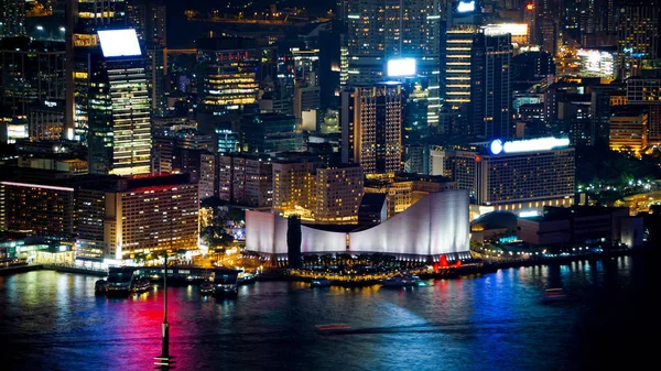 Hong Kong Victoria harbour and its iconic red ancient junk sail zoom shot from the Peak at night