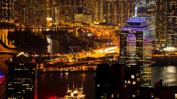 Hong Kong night view boat parking port surrounded by skyscraper — Stock Photo, Image
