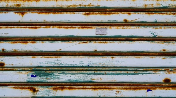 Metal shutter door. Gry color with rust running from humidity te — Stock Photo, Image