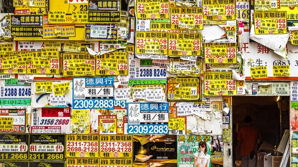 Wall texture cover full of yellow advertising flyer on abandoned building in Hong Kong — Stock Photo, Image
