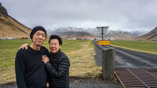 Asian senior couple travel with tour to Iceland fun