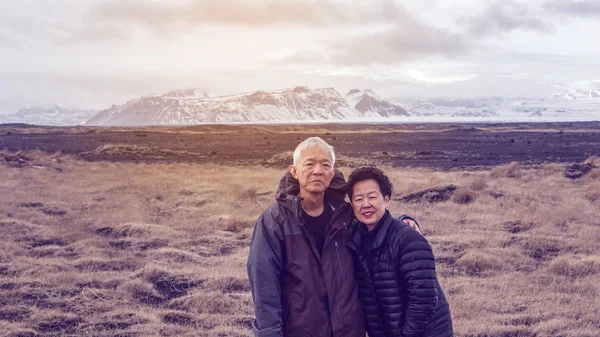 Asian senior couple travel with tour Iceland fun trip