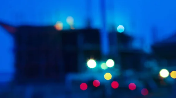 Blur construction crane truck working on structure at night — Stock Photo, Image