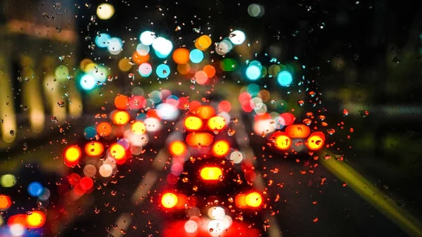 Blur city traffic light rain drops on window high angle — Stock Photo, Image