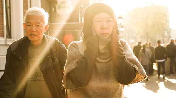 Asian senior couple walking in Europe tried trip in morning sunl — Stock Photo, Image