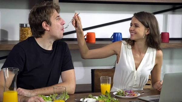 Caucasian couple feeding and have fun conversation while eating