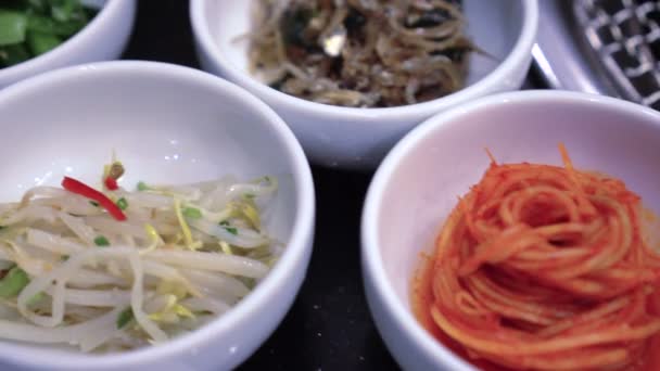 Korean food variety of BBQ side dishes kimchi and other things — Stock Footage Korean Food Variety Bbq Side Dishes Kimchi Other Things Royalty Free Stock Video
