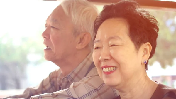 아시아 의연로 부부는 햇살을 받으며 대중교통을 즐기고 — 스톡 사진