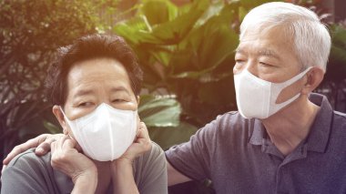 Çinli yaşlı çift maske takarak Coronavirus kirliliğini önlüyor