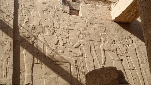 Luxor Egypt Karnak temple sandstone craved hieroglphic wall and column pharoah and anceint story