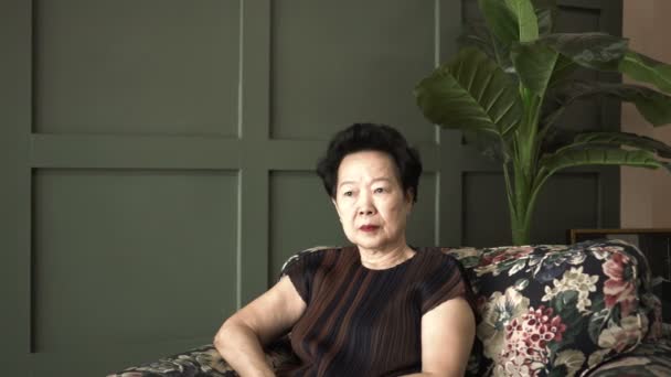Asiática Anciana Mujer Preocupación Expresión Mientras Sentado Casa Solo — Vídeo de stock
