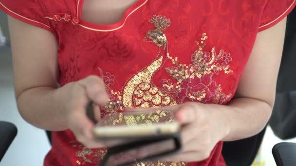 Woman Red Traditional Attire Using Phone Chinese New Year — Stock Video