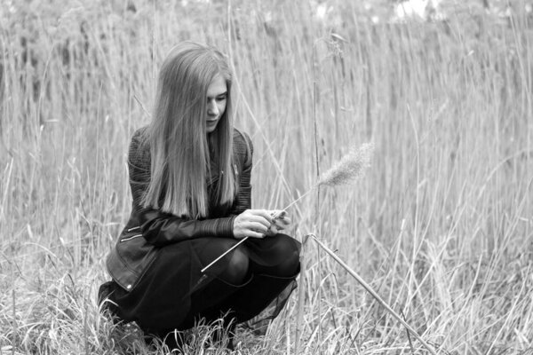 Beautiful young woman outdoor, in a reed field (black and white)