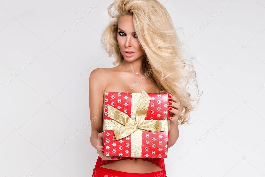Three beautiful sexy blonde female models snowflakes dressed as Santa Claus erotic red lingerie with white