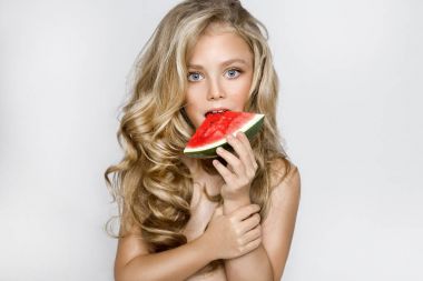 Beautiful blonde young model, cute girl, holding watermelon and looking cute. clipart