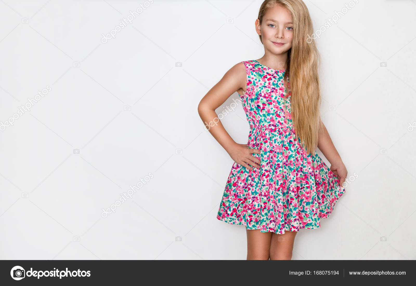Beautiful Little Girl With Long Blond Hair And Blue Eyes Standing