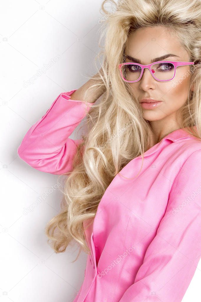 Portrait beauty blonde female model with amazing long  hair and perfect face clean young skin care posing on a white background in elegant eyeglasses