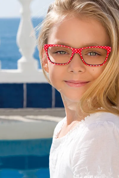 Retrato de una linda niña en gafas sobre un fondo blanco —  Fotos de Stock