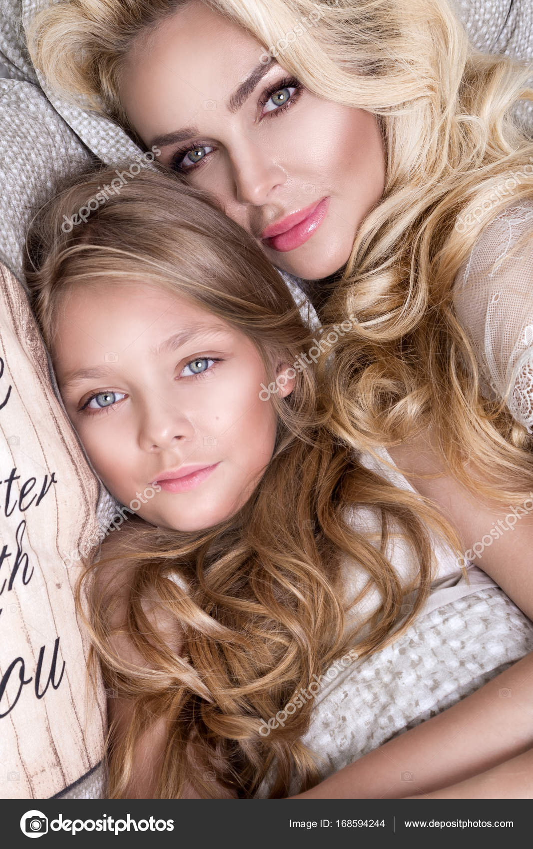 Portrait of the beautiful blonde woman mother and daughter on the