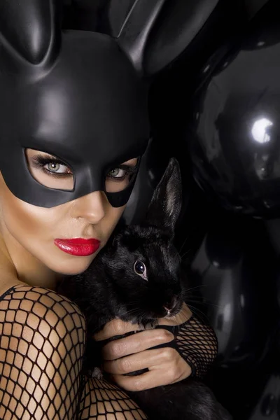 Sexy female model dressed in costume Easter bunny and black rabb — Stock Photo, Image