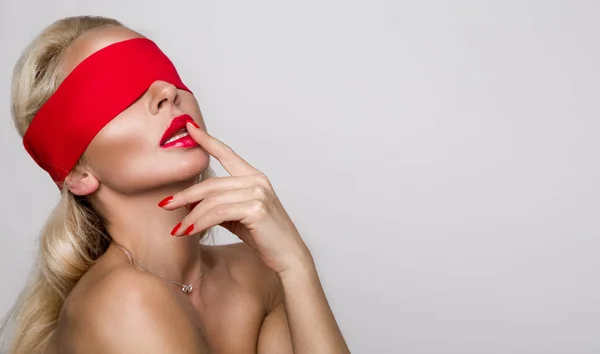 Beautiful sensual woman model with red lips and nails is tied, covered headband eyes and looks erotically — Stock Photo, Image