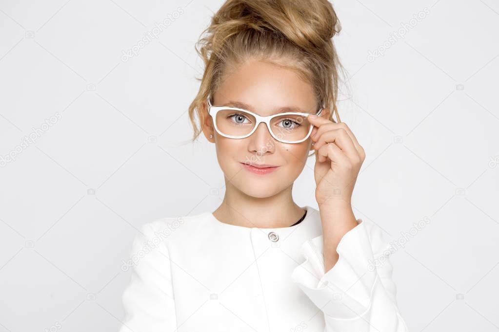 Cute, beautiful blonde young girl with amazing hair and glasses . Beauty, elegant and joyful girl.