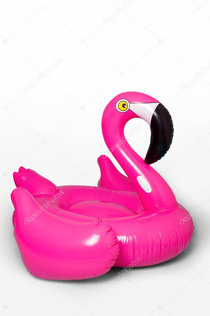 Pink, trendy, blown beach flamingo on a blue background. Hit the