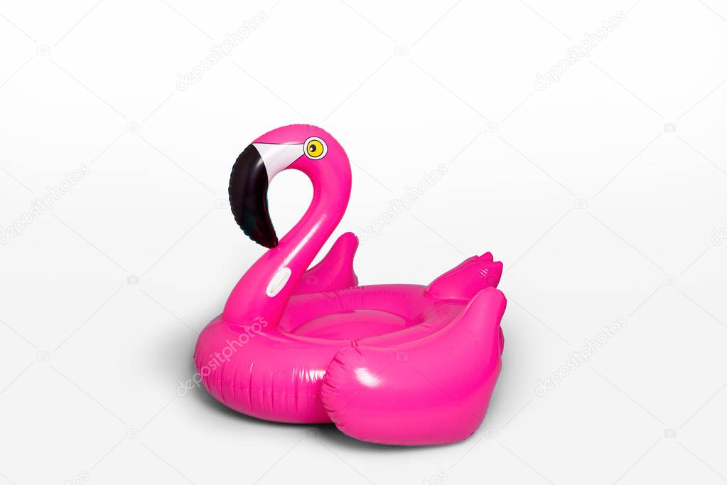Pink, trendy, blown beach flamingo on a blue background. Hit the