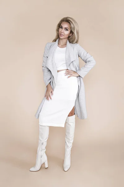 工作室里的高级时装模特 穿着灰色外套和白色靴子的漂亮女士 秋天的冬季白色风格 装扮时髦的时装模特 — 图库照片