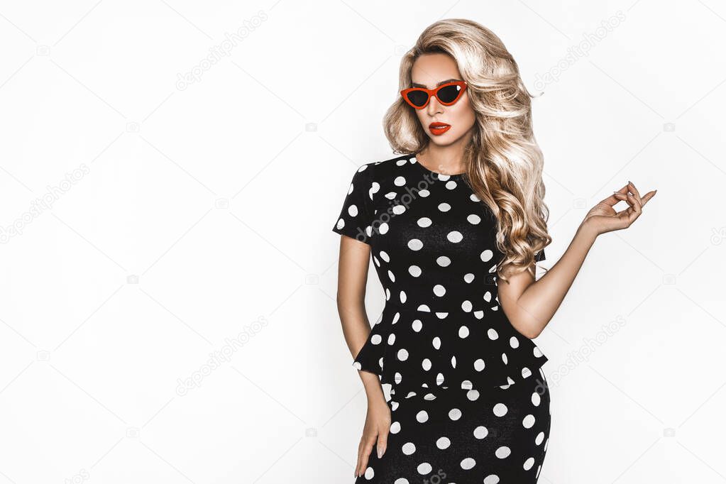 Beautiful, sexy blonde woman in elegant clothes in polka dots