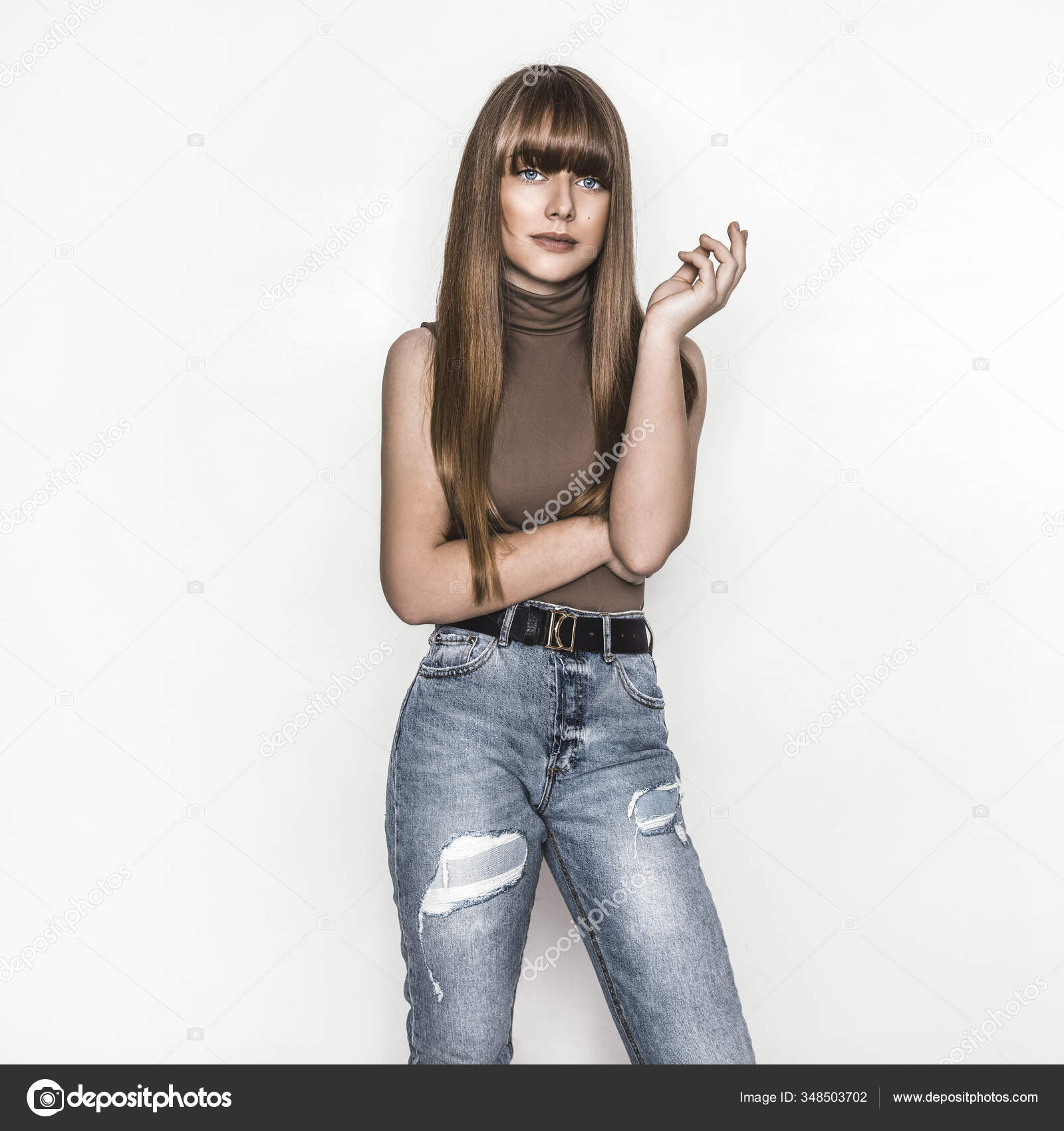 Playful beautiful teenage girl with messy hairstyle wearing jeans and top  with open-shoulder design, smiling cheerfully, standing isolated against  white wall background with copy space for your text Stock Photo | Adobe