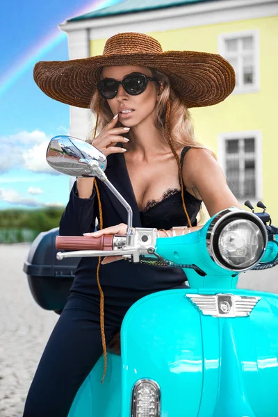 Attractive woman riding on motorbike in street, summer vacation style, traveling, smiling, happy, having fun, stylish outfit, adventures. Spring fashion model. Girl on a pink scooter - Image