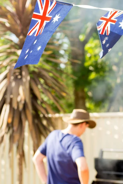 Australia Day background - blurred man wearing a hat staying near open BBQ. Empty space for text input — Stock Photo, Image