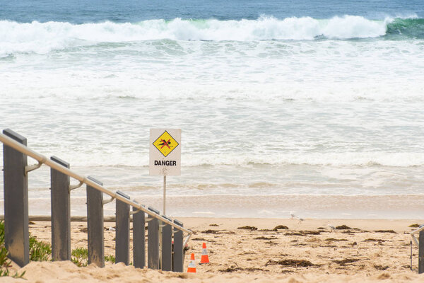 Danger sign at the entrance to the beach in Australia