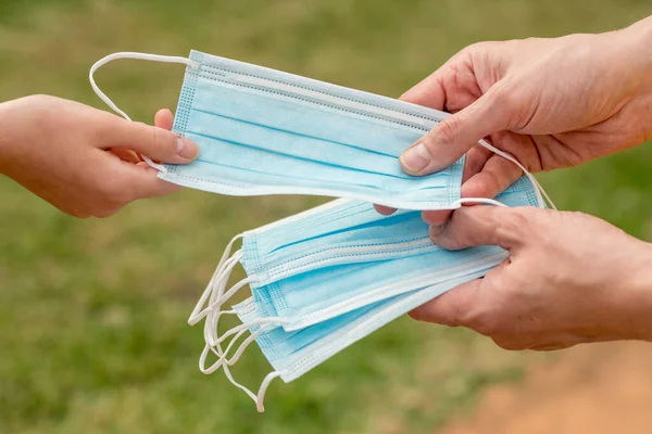 Hands Holding Giving Protective Disposable Face Mask Another Person Concept — Stock Photo, Image