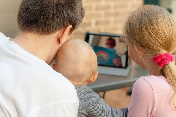 Family video chat - a man with two children using tablet for communication