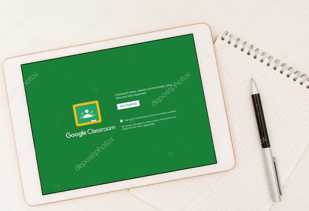 Sydney, Australia - 2020-04-06 Hands holding a tablet with Google Classroom application on screen. Coronavirus lockdown online education concept