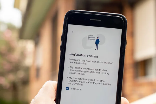 澳大利亚悉尼2020 26手握Covidsafe应用程序的电话 登记许可筛选 澳大利亚政府推出了新的Covid 19跟踪应用程序 — 图库照片