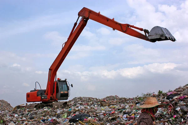 在垃圾填埋场的垃圾堆上做反铲工作.在堆填区工作的人. — 图库照片