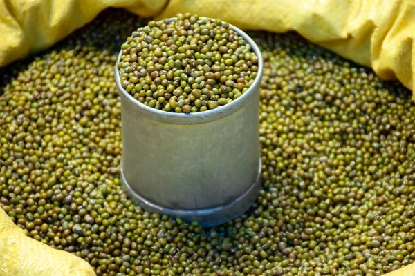 Green mung beans in can and the sack for sale in market.