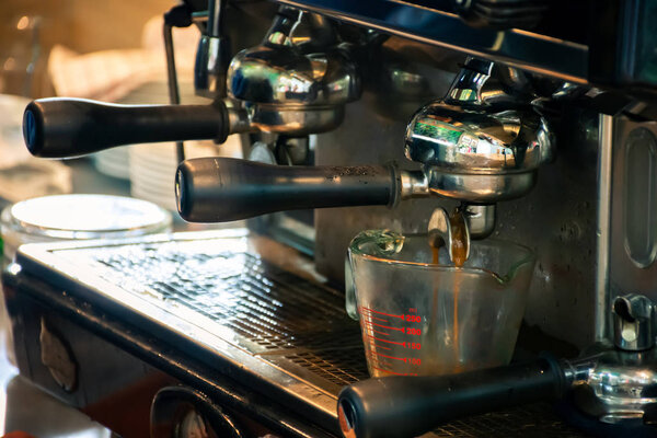 Coffee machine preparing espresso coffee in cafe.