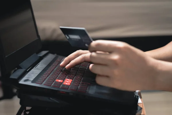 Man Hands using laptop computer and holding credit card. Online shopping and online payment concept. — 스톡 사진