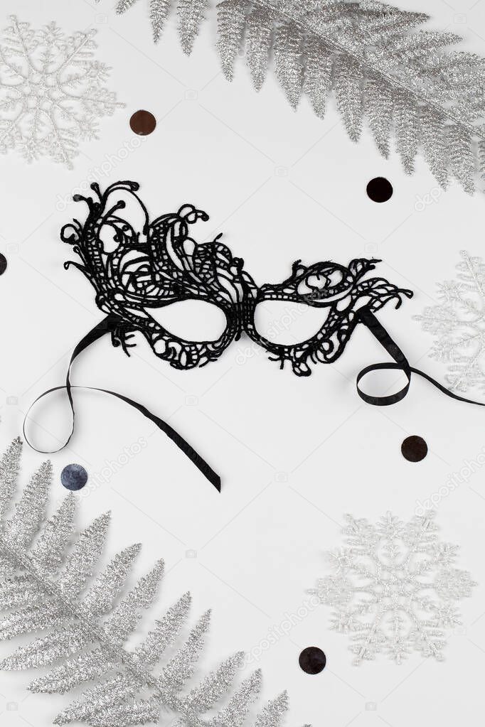 Beautiful carnival black mask and christmas decoration on white background . Christmas concept.