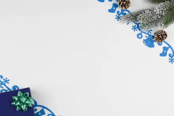 Χριστουγεννιάτικο φόντο. Χριστουγεννιάτικο κουτί, κώνο, μπλε τσόχα διακόσμηση και κλαδιά χριστουγεννιάτικου δέντρου σε λευκό φόντο — Φωτογραφία Αρχείου
