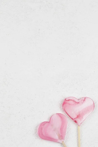 하얀 배경에 있는 롤리팝 캔디처럼 분홍색 하트 두 개. — 스톡 사진