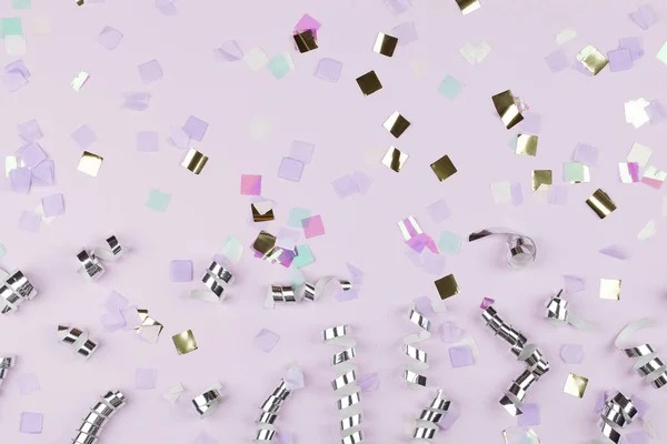 Festive party border or frame of silver spiral streamers and confetti on pink background — 스톡 사진