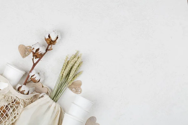 Wooden hearts, cotton flower and eco natural paper cups, string bag, wheat on white background — 스톡 사진